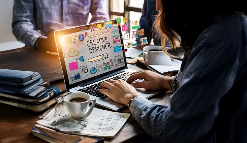 Creative Designer Course | Arena Animation Creative designer working on laptop with digital design interface and visual elements