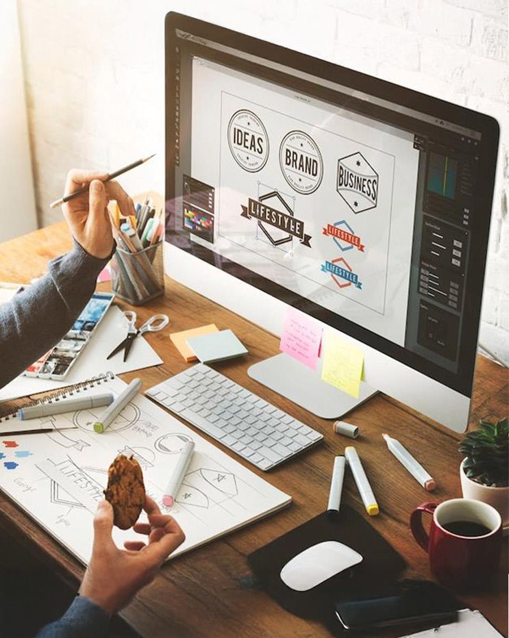 Graphic designer creating logo concepts on desktop